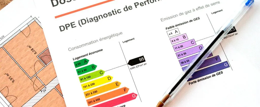 Un document de performance énergétique présentant les notes de consommation et d'émissions est présenté, accompagné d'un stylo et d'un plan d'architecture. L'efficacité énergétique est évaluée de A à G. Accédez facilement à des informations similaires via Total Énergie Mon Compte pour une gestion énergétique complète.